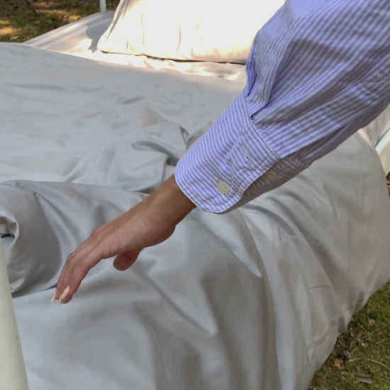 Lyocell Bettwäsche Set mit Eukalyptus Zellstoff aus 100% Tencel in Grau, Hand streicht über das Bett